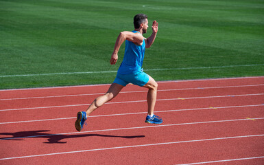 athletic muscular man runner running on stadium, energy