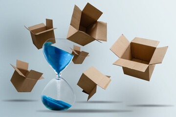 cardboard boxes and an hourglass. Express delivery in short time concept. Temporary storage,...