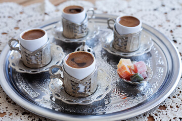 Turkish and Greek coffee on metal tray, lace cover on wooden table