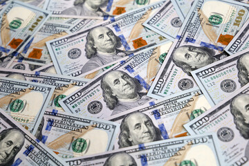 A lot of one hundred US dollars bills, paper currency for background. Concept of american and global economy, exchange rate