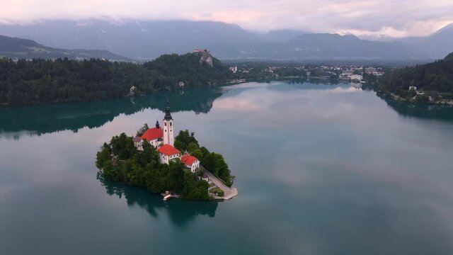 Sunrise at Bled Lake in Slovenia. Alpine Lake with Church on Island. Drone View Real Time