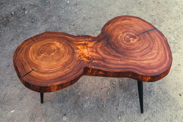 Live edge elm slab coffee table with epoxy finish. Woodworking and carpentry production. Close-up....
