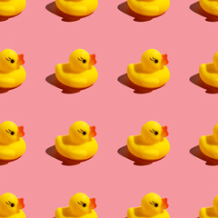 Seamless pattern with rubber duck on pink background.