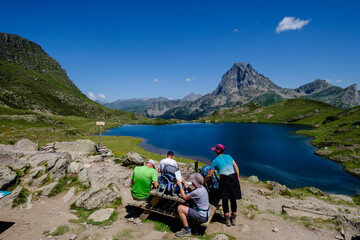 Fototapeta premium people on Ayous hut, Gentau lake, Ayous lakes tour, Pyrenees National Park, Pyrenees Atlantiques, France