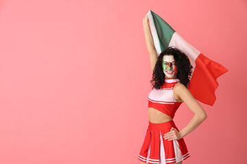 Beautiful cheerleader with Mexican flag on pink background