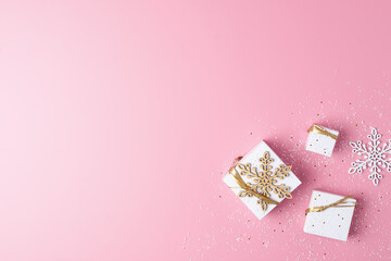 Christmas decorations with gifts on pink background. Flat lay, copy space