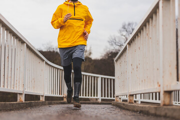 Man jogging on a bridge pathway