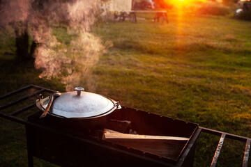 Cooking in a pot on the fire. Camping concept.