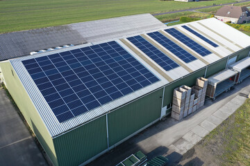 Flower bulb company with solar panels in a row on a roof. Photo taken with a drone