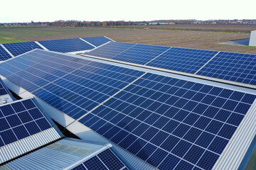 Solar panels on a roof of a company Solar panels are a cheap and sustainable way to obtain energy...