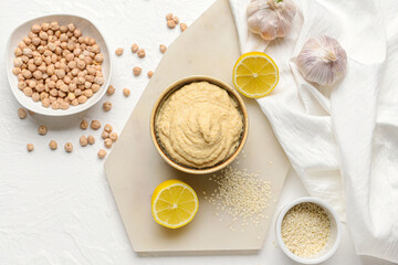 Composition with tasty hummus on light background