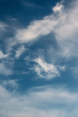 blue sky with clouds and crescent moon