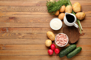 Different ingredients for okroshka on wooden background