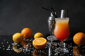 Fototapeta na wymiar Glass of tasty summer cocktail on dark background