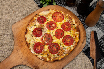 Neapolitan Brazilian pizza with mozzarella cheese and tomato slices with oregano