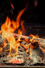 A barbecue grill with high flames