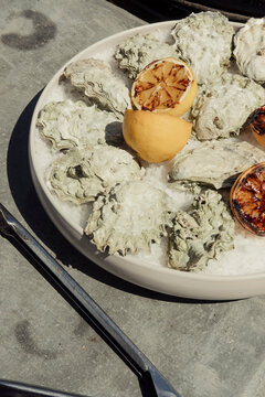 Oysters on a bed of ice with grilled lemons