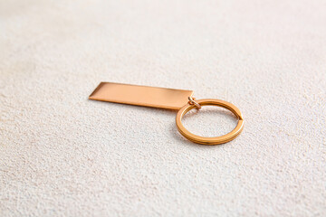 Stylish keychain on light background