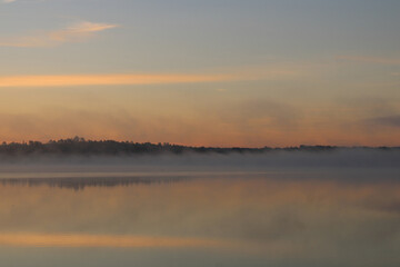 Obraz na płótnie Canvas Orange-Blue Morning Mist on Lake