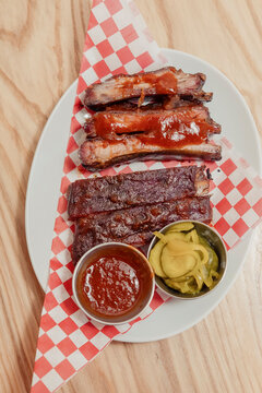 A plate of Southern style BBQ ribs with homemade pickles