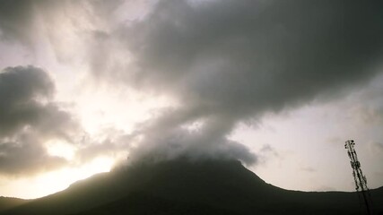 Beautiful view of clouds and fog on top of Girnar mountain during sunrise