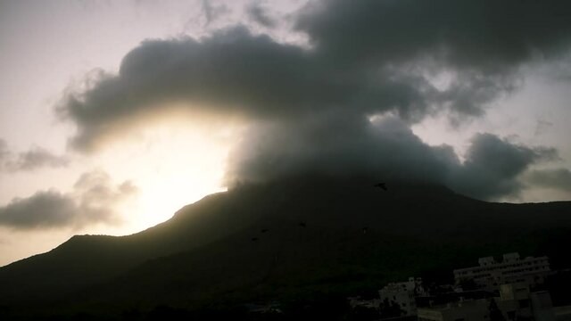 Beautiful view of clouds and fog on top of Girnar mountain during sunrise