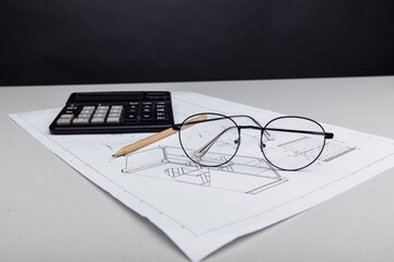 Architectural plan, glasses and calculator. Building cost