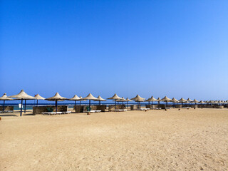 View on great sandy beach in Marsa Alam ,Egypt with umbrellas and sun loungers