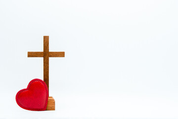 Wood crucifix and red heart on white background. Concept of hope, faith, love, symbol christianity, religion, church online, Easter time, God loves world, Jesus loves you, background with Copy Space