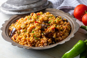 Traditional delicious Turkish food; Bulgur pilaf with eggplant and vegetables. (Turkish name;...