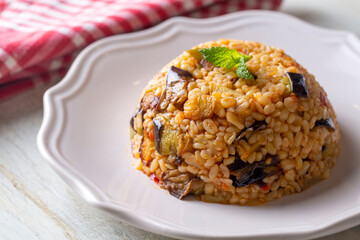 Traditional delicious Turkish food; Bulgur pilaf with eggplant and vegetables. (Turkish name; Patlicanli bulgur pilavi)