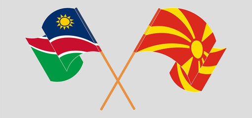 Crossed and waving flags of Namibia and North Macedonia