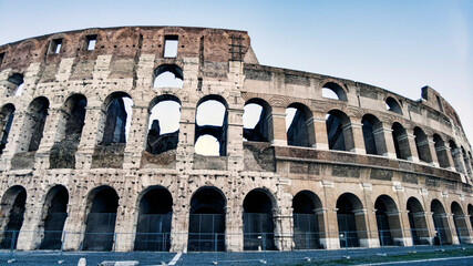 Fototapeta premium Colosseum or amphitheater Flavius in Italian Colosseo, the bigger ancient amphitheater in the world, heritage of Ancient Rome and famous world attraction at Rome