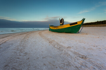 A fishing wooden boat moored by the beach, Debki, Poland.