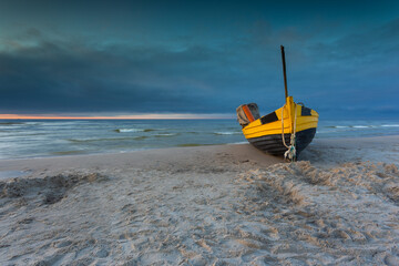 A fishing wooden boat moored by the beach, Debki, Poland.