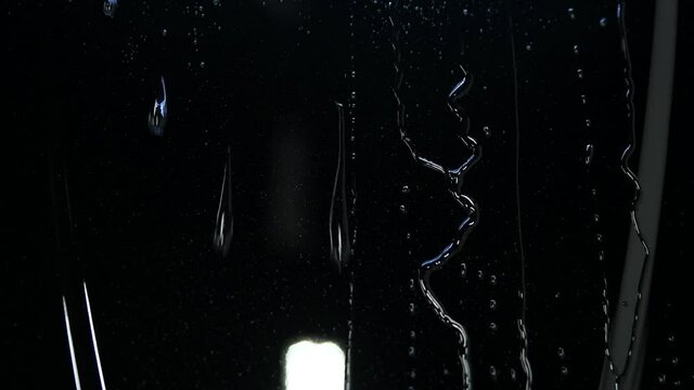 Video showing advantages of using ceramic coating on mini car hood. Hydrophobic effect on water pouring on metal surface