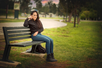 Young woman sitting on a park bench