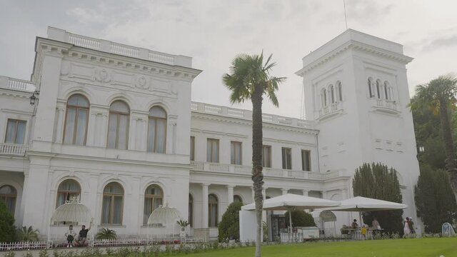 Facade of Livadia Palace in Crimea. Action. Beautiful facade of white old building with columns in European style. Tourist former palace in Crimea