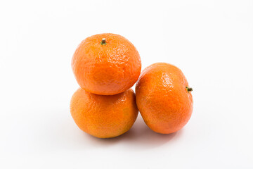 three tangerines on white background
