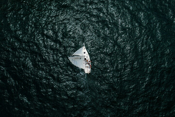 Sail Boat on the Pacific Ocean as seen from drone straight down.