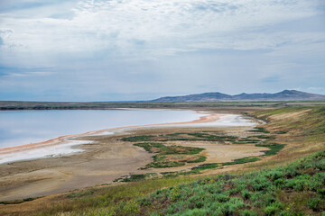 Lake Koyashskoye. A pink-orange lake with a salt crust on the shore