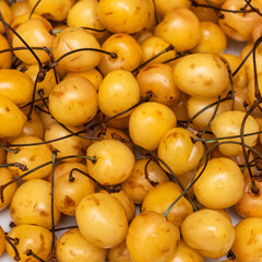 Background with yellow cherry. Sweet ripe yellow cherry plum heap. Healthy eating concept.
