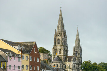 Fototapeta na wymiar Towers of st Finbar's cathedral and rooftops of the surrounding buildings of the city of Cork, republic of Ireland
