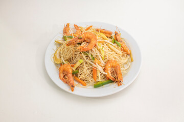 Chinese rice noodles with fried prawns, bean sprouts and wok-sauteed vegetables on white plate