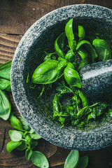 Making Homemade Basil Pesto in Granite Mortar with Fresh Herb