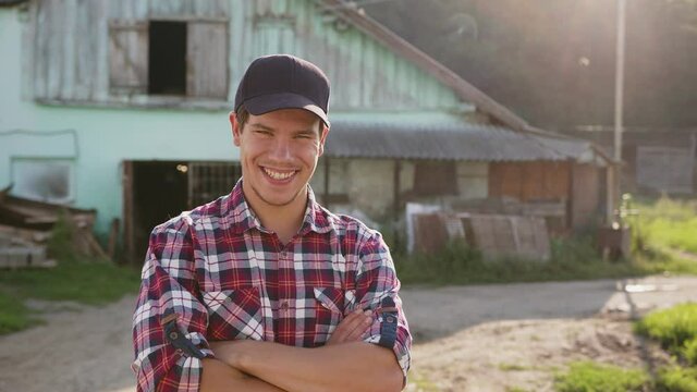 A sincere smiling farmer rejoices at the beginning of a new day