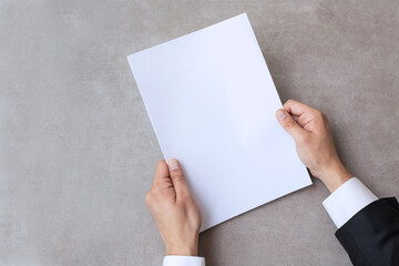 Male hands holding blank white paper