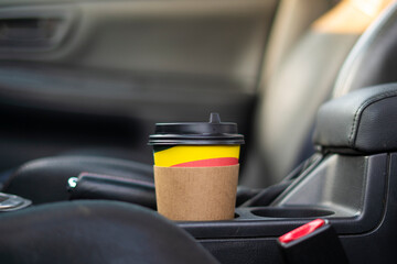 takeaway paper coffee cup inside the car