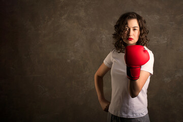 a boxer female in red boxing gloves, a feminist, copy space for your text