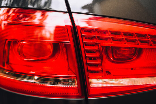 Taillight, large headlight of a modern car in red close-up. Photography, concept.